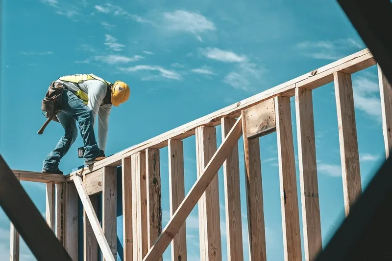 Carpenter working on the wood framing of a home under construction
